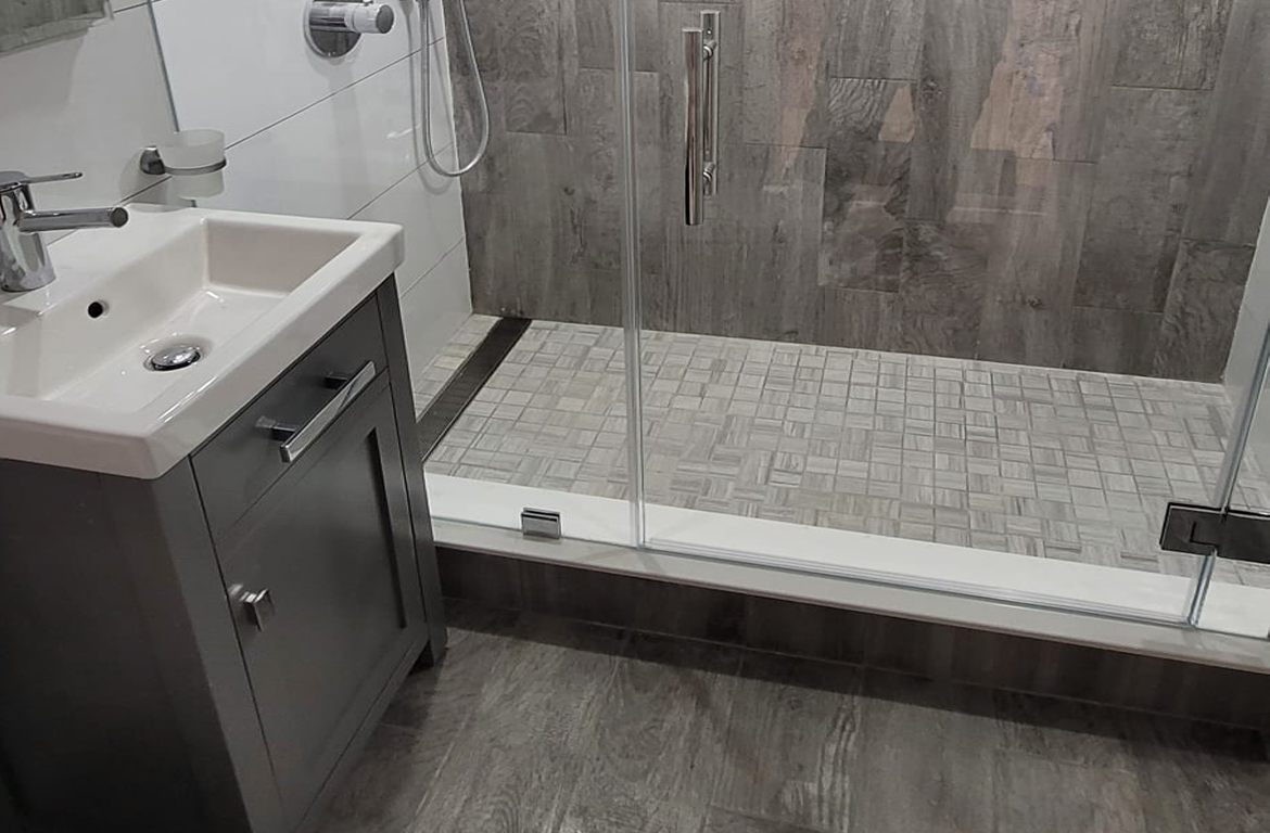 A beautifully renovated bathroom featuring a modern soaking tub and elegant tile work, showcasing the concept of rebath as a way to refresh and rejuvenate your space.