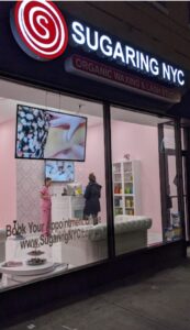 Sugaring NYC Brooklyn entrance with a led neon sign board in the evening