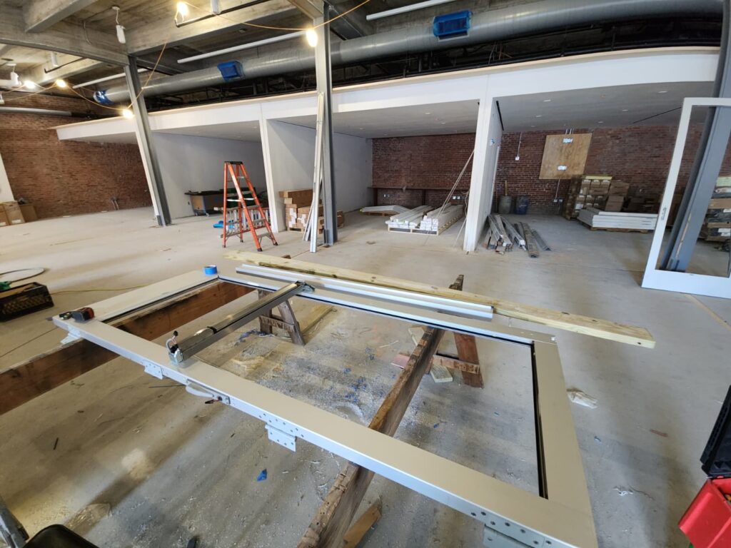 Commercial aluminum door assembly on site during the College of Staten Island door replacement project