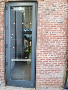 Custom commercial single aluminum door installed at the College of Staten Island