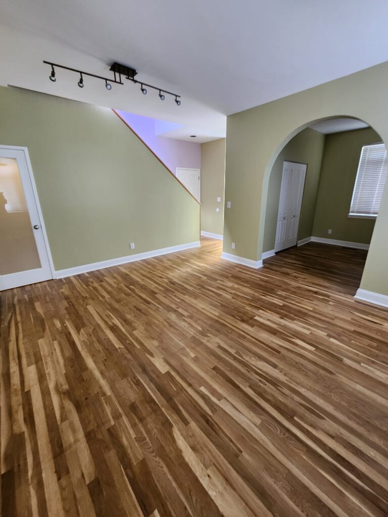 Finished living area with refinished hardwood floors after a residential renovation in Dobbs Ferry, NY