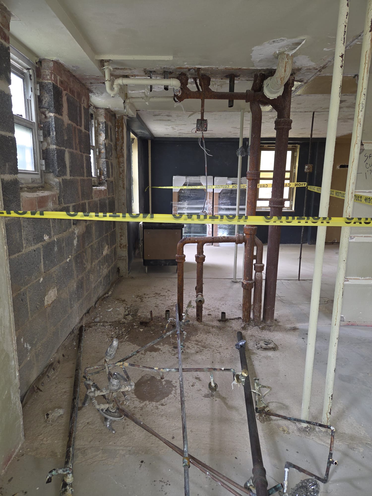 Exposed plumbing and rough work during a full Manhattan apartment renovation.